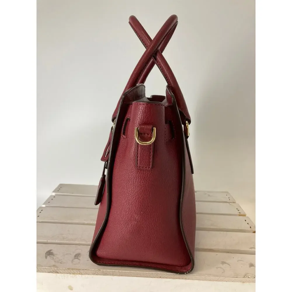 MICHAEL KORS, LARGE WINE LEATHER HANDBAG WITH LOCK CHARM.